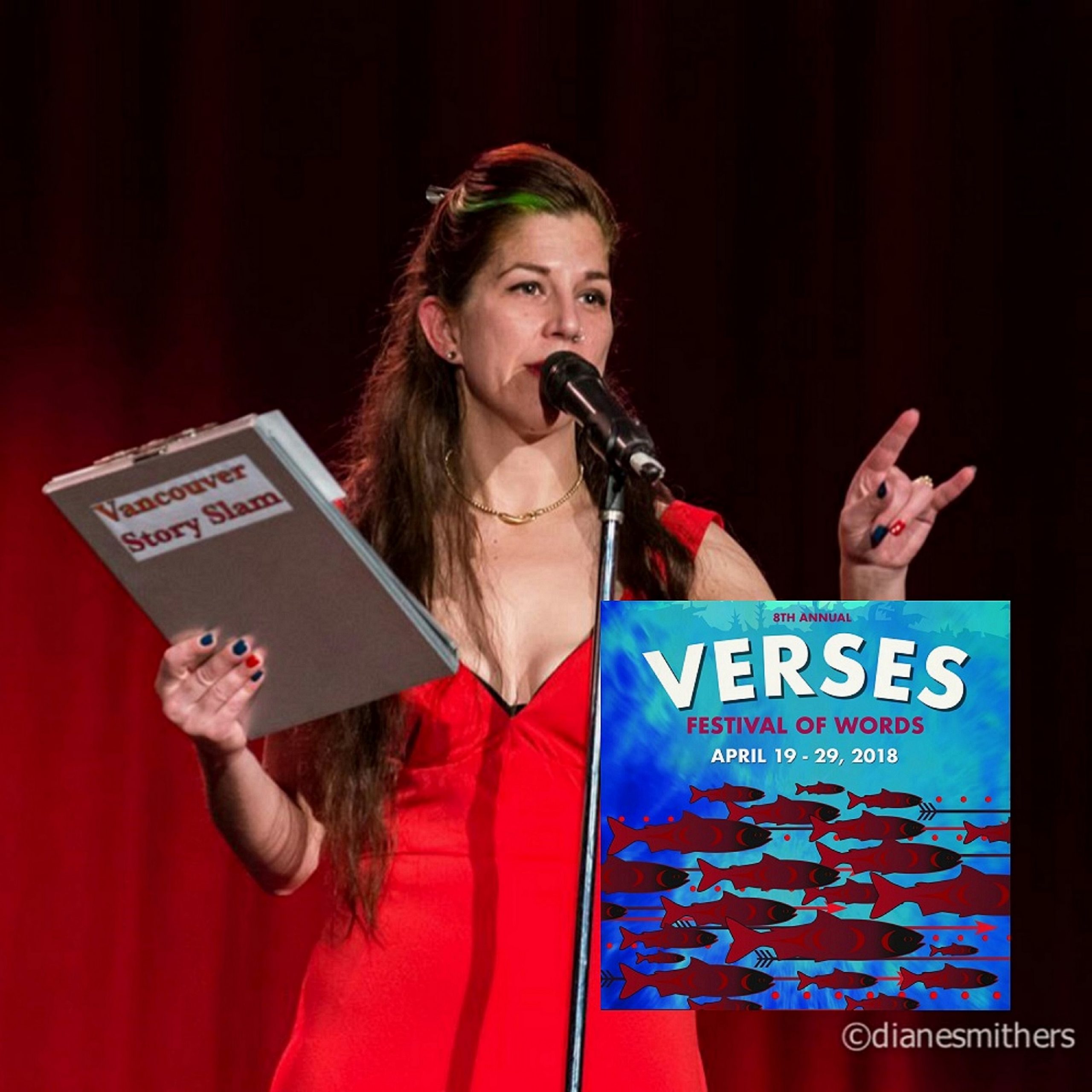 [ID: Photograph of Vancouver Story Slam organizer and host Susan Cormier standing on stage behind a microphone. She holds a clipboard in her right hand with a Vancouver Story Slam label while gesturing with her left hand. She has bright blue and red nail polish. She is wearing a red dress. Her long hair is clipped back at the top. An insert of the Verses Festival of Words poster is at the bottom left with an array of stylized red salmon, arrows and dots moving from right to left across a blue background. It includes the words Eighth Annual Verses Festival of Words April 19 - 29, 2018. /end ID]